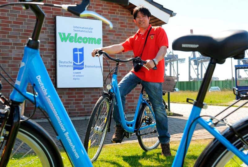 A seaman on shore leave renting a bike in a Seamen’s Club in Bremerhaven, Germany.