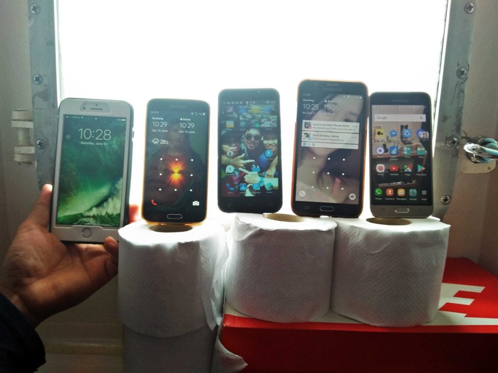 Cellphones placed near the porthole of a cabin to receive mobile data internet connection while onboard.