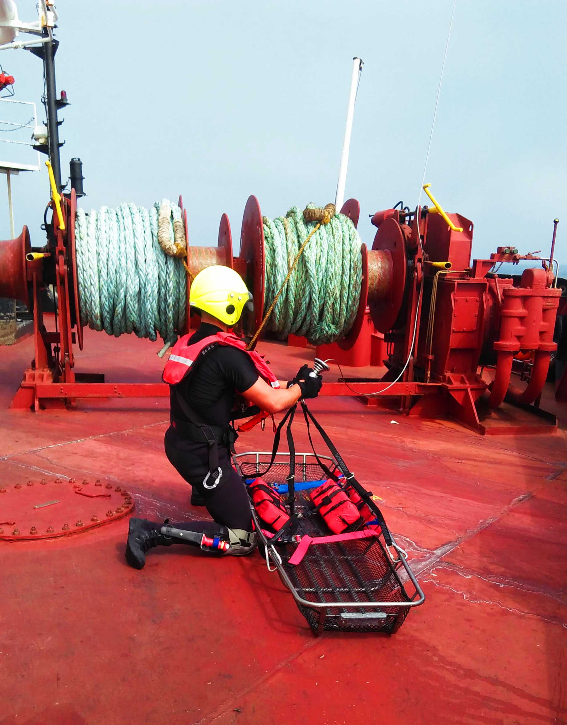 Search and Rescue Volunteer landing on the poop deck of a ship with stretcher