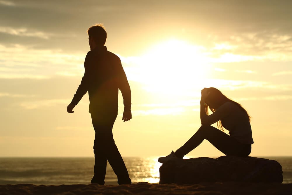 A couple breaking up their relationship near the sea shore.