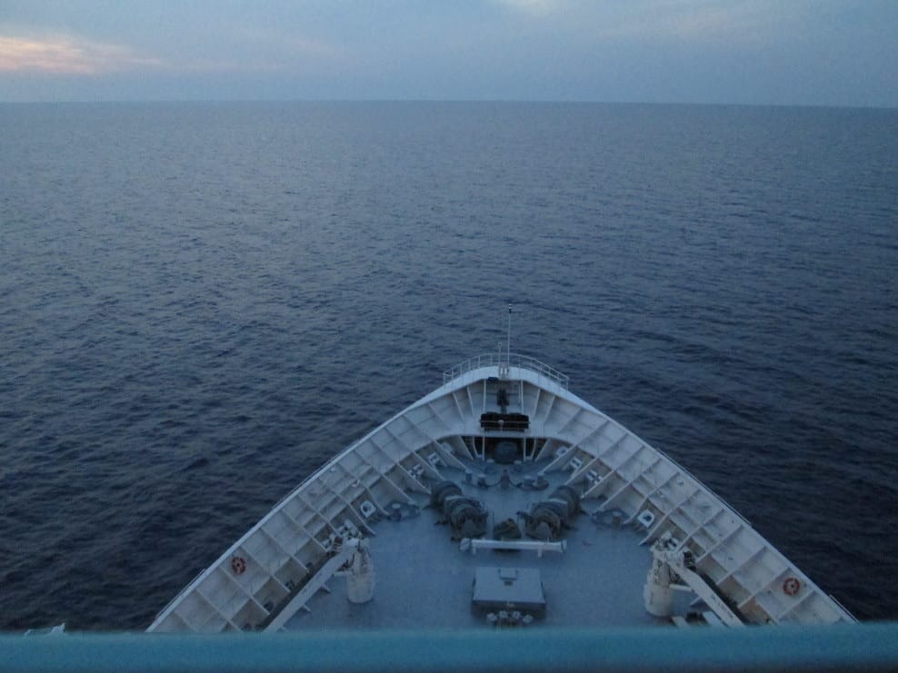 A vessel sailing on a calm water and showing only her bow.