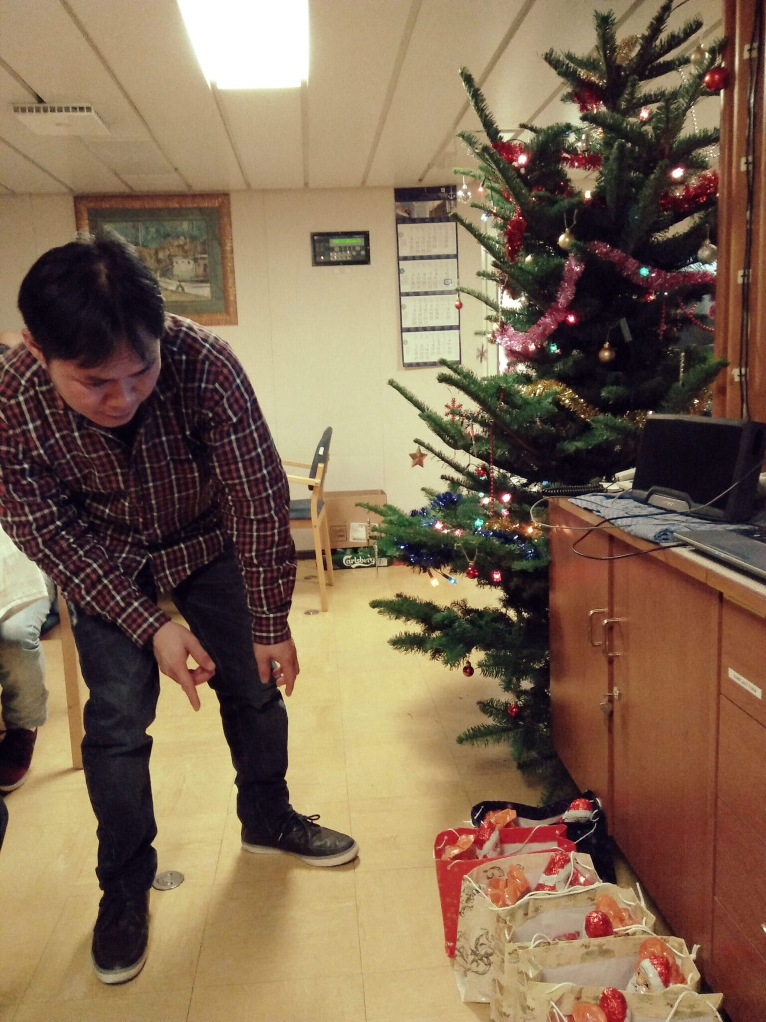 A crew looks over the gifts from the company during Christmas on board.