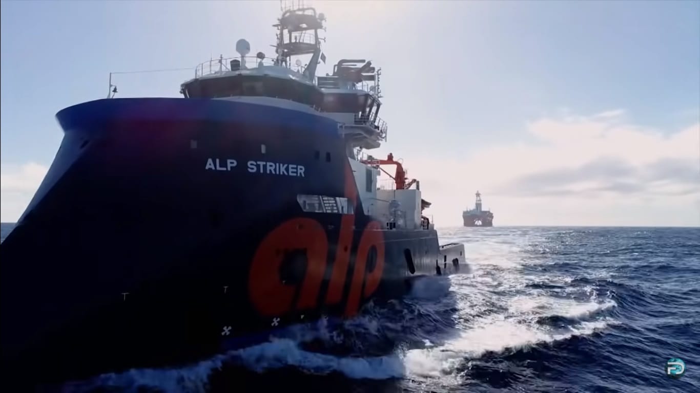 Powerful tugboat ALP Striker towing an Oil Rig.