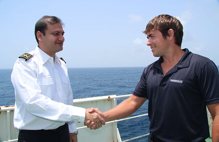 An Ambrey security personnel shaking hands with the Captain.