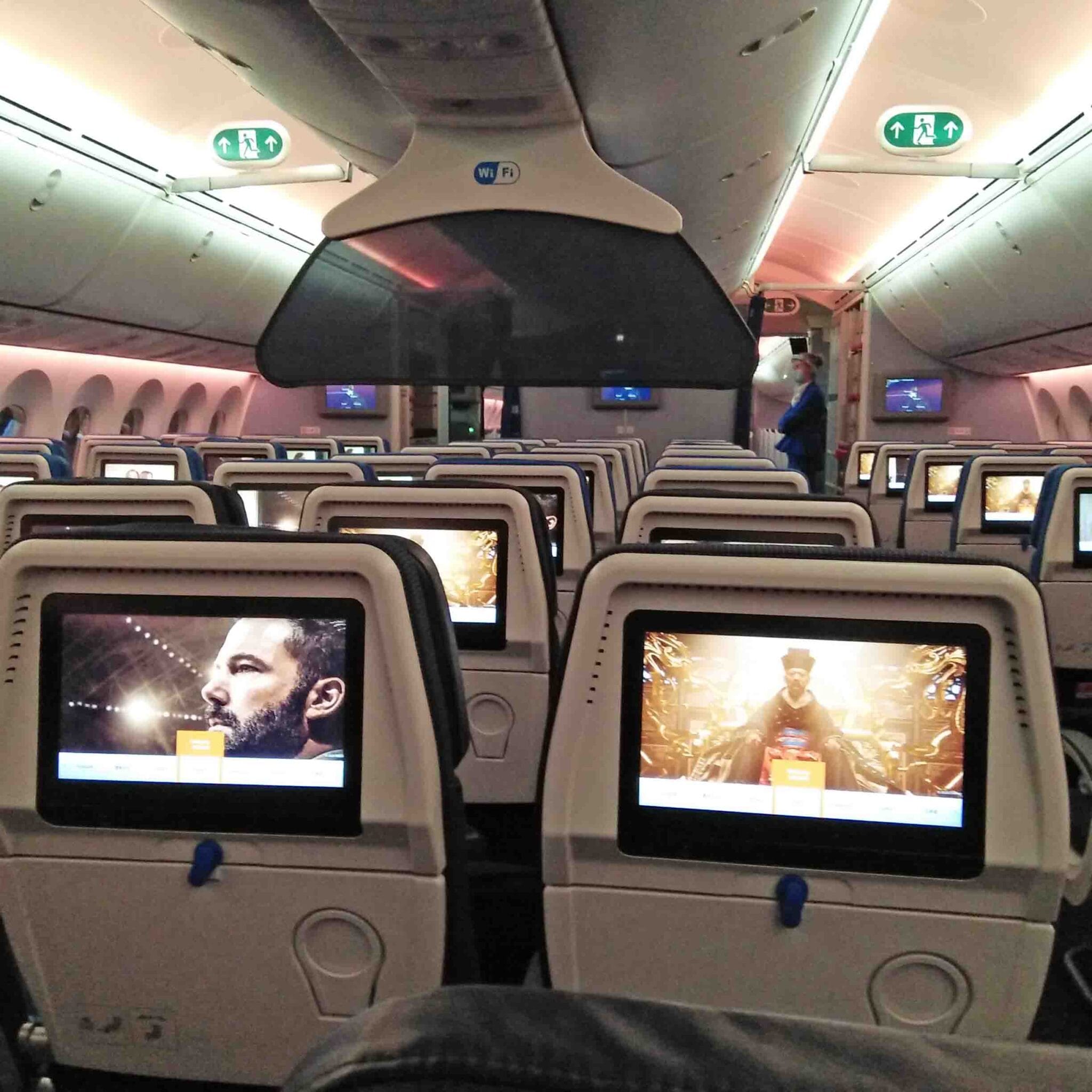 Mostly empty seats inside an airplane bound for international flight.