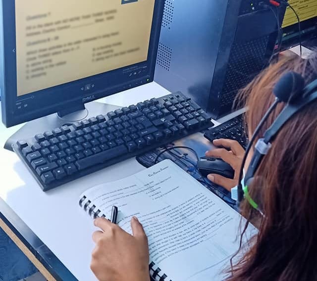 A woman using a computer during her training program.