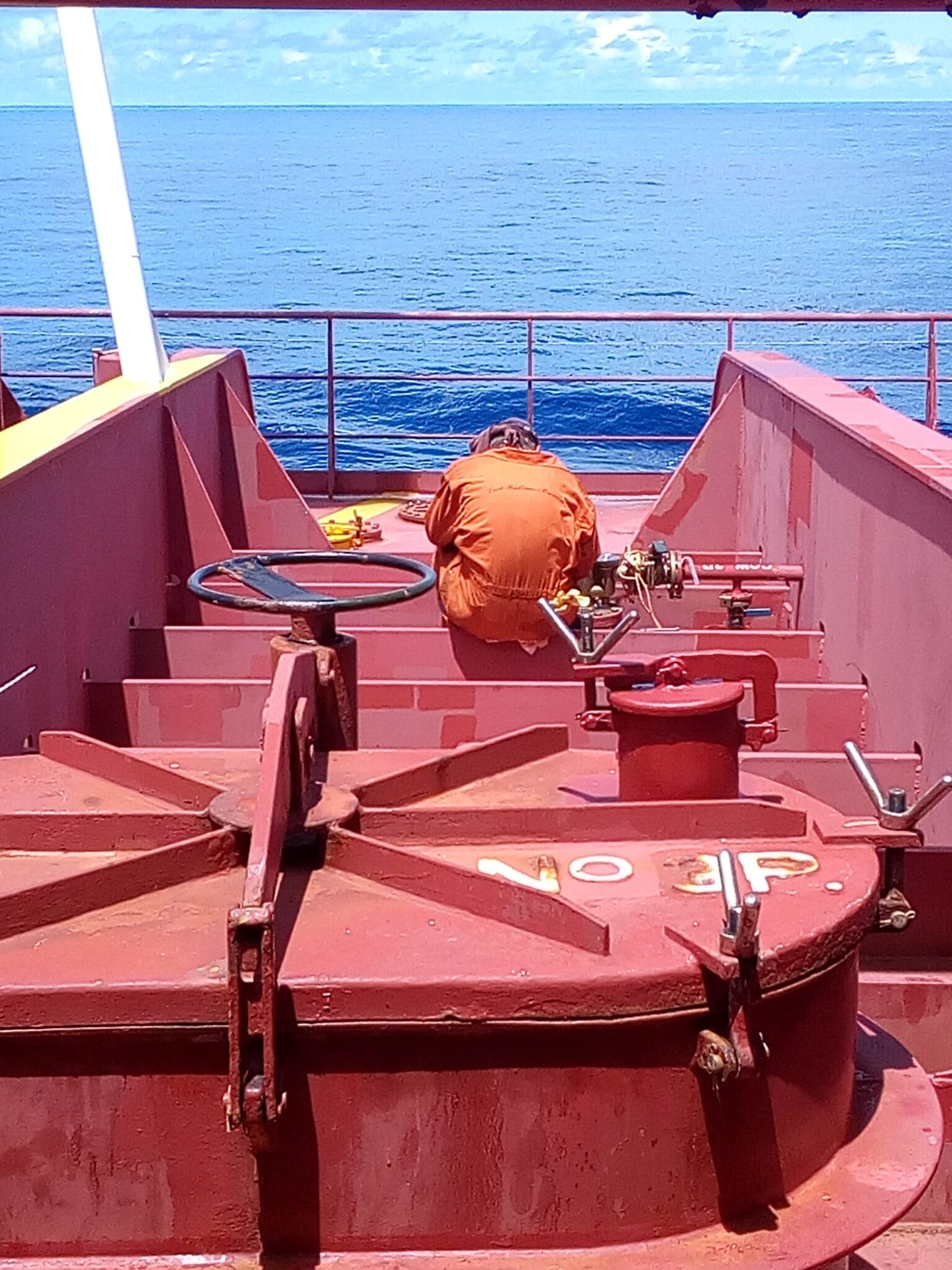 A crew fixing the fixed washing machine on deck near the 3P cargo tank.
