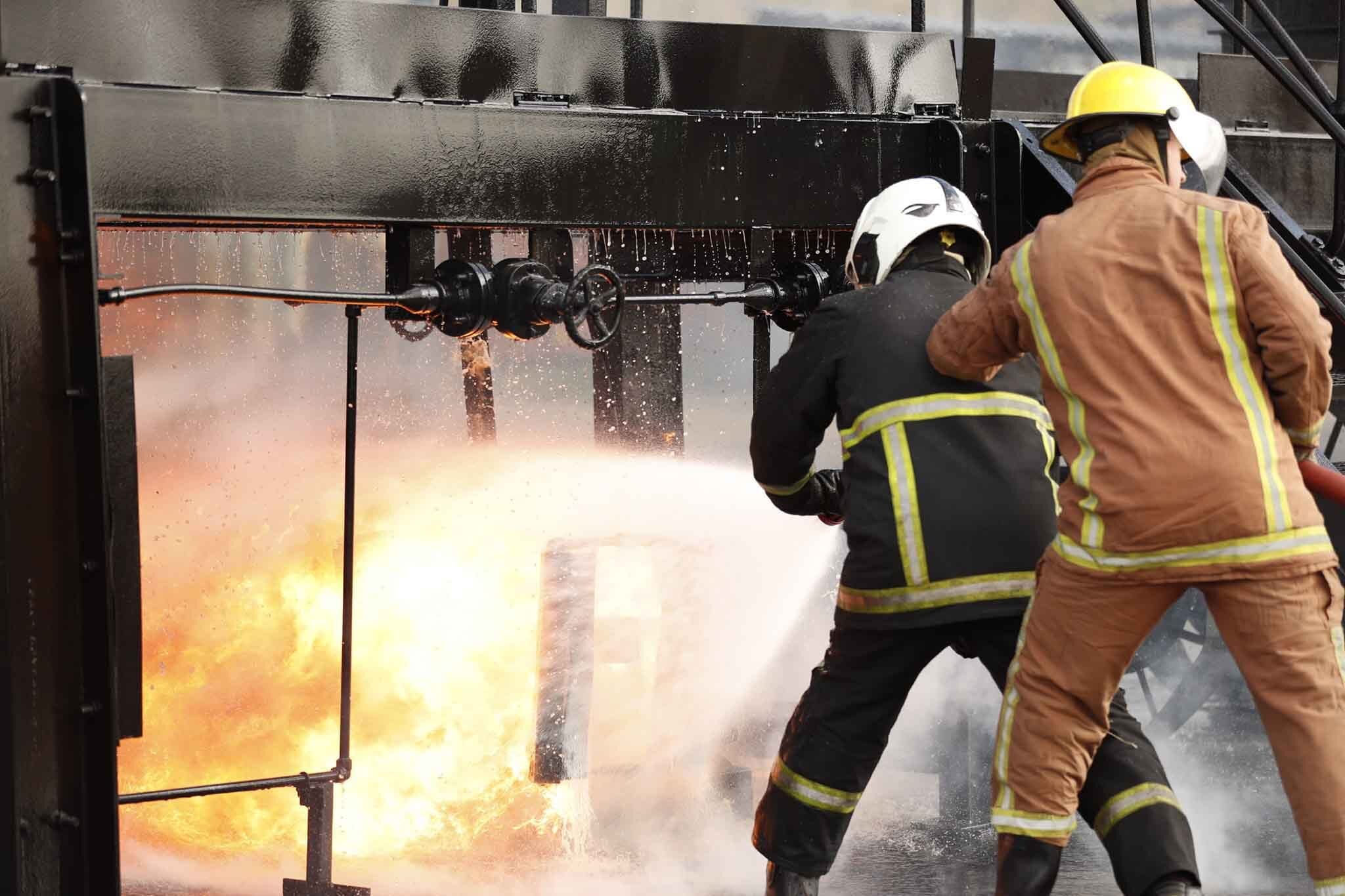 Extinguishing a fire using a fire hose without wearing BA sets.