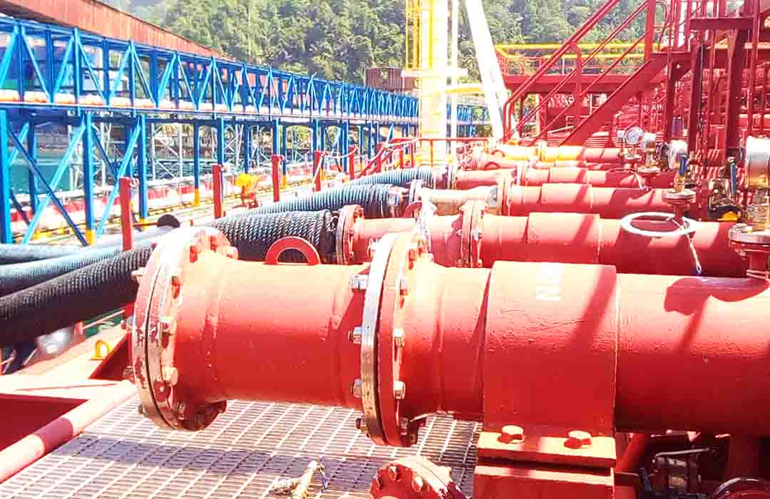 Cargo manifold with three cargo hoses connected and used during loading operation