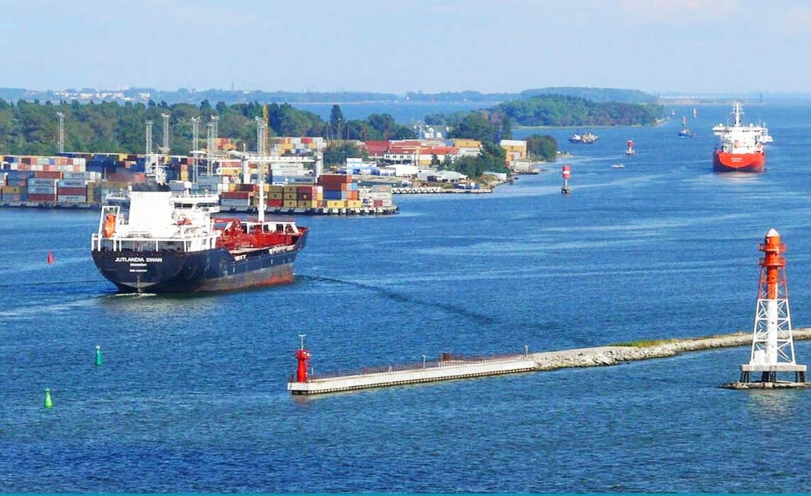 Ships entering the breakwater while passing green and red buoys.