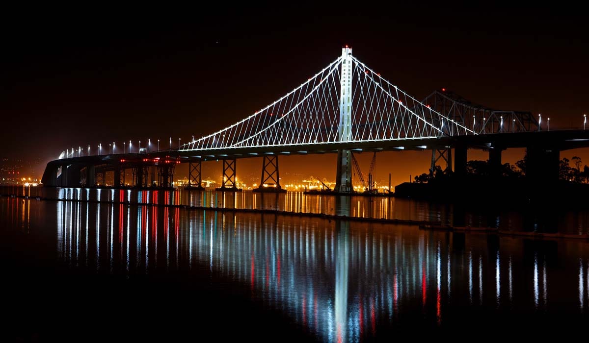 The city lights and the lights from the bridge looks astonishing as it is reflected on the calm waters.