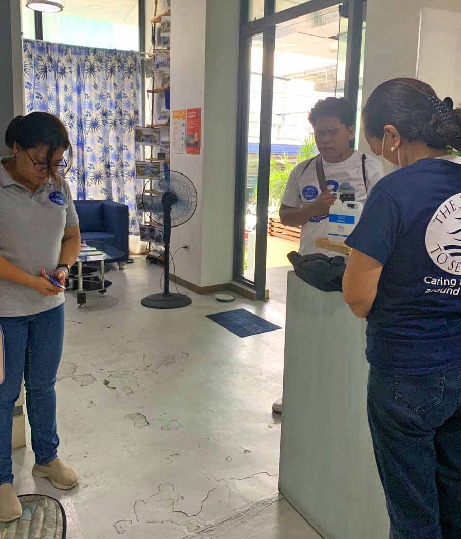 Staffs praying inside the lobby of Mission to Seafarers Philippines.