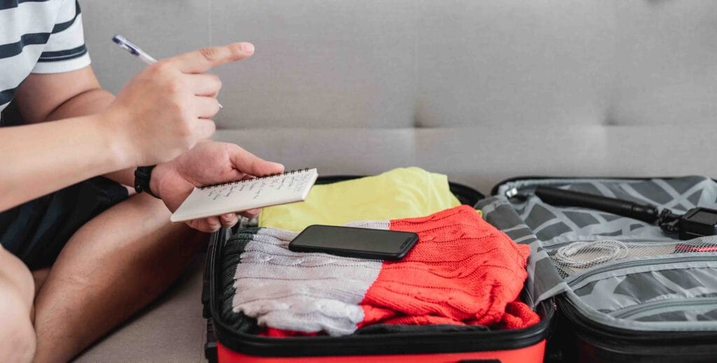 A seafarer double checking his list of items packed inside his luggage before signing on.
