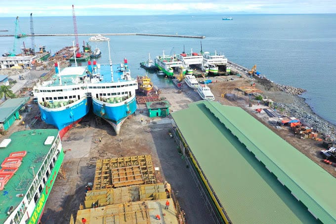 Two passenger ships on a drydock in San Pedro Shipyard.